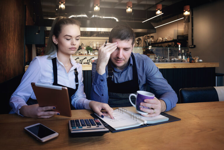 Young entrepreneurs going over documents in the restaurant